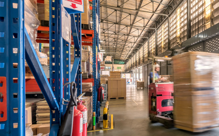 Blured Image Of Person On Forklift Moving Large Boxes