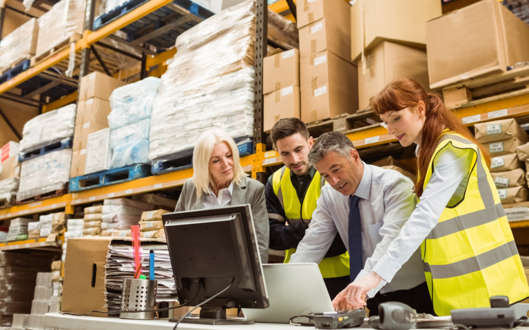 Team reviewing Captain software on warehouse screens