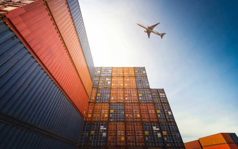 Freight crates with a cargo plane overhead