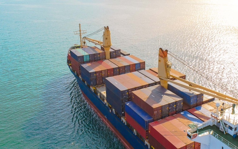 Overhead view of a blue cargo ship at sea