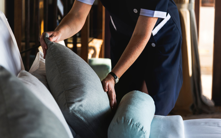 Hospitality worker preparing a hotel room