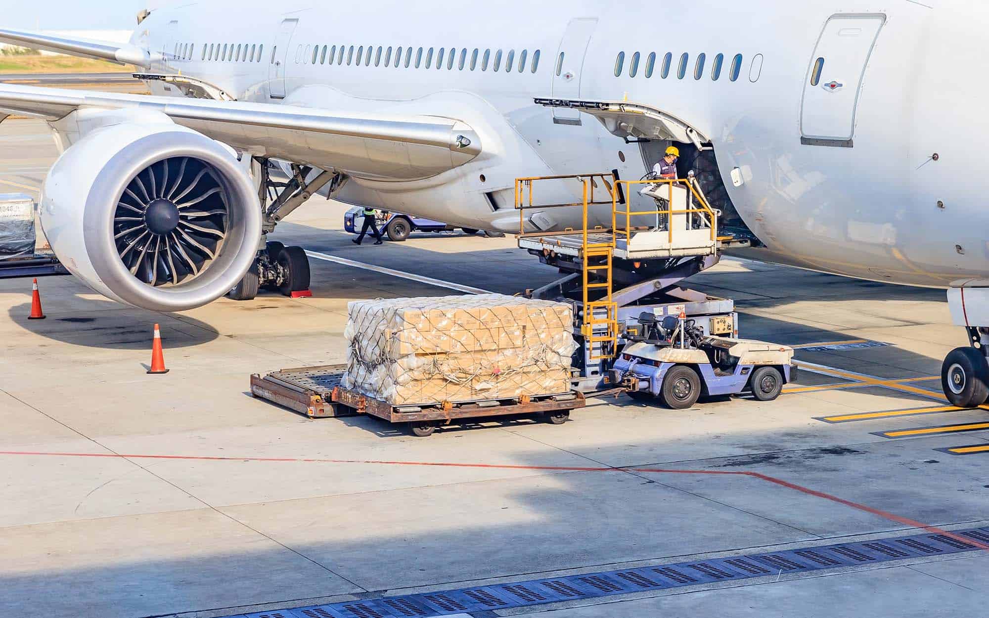 Palletized air freight being loaded onto a wide-body cargo aircraft