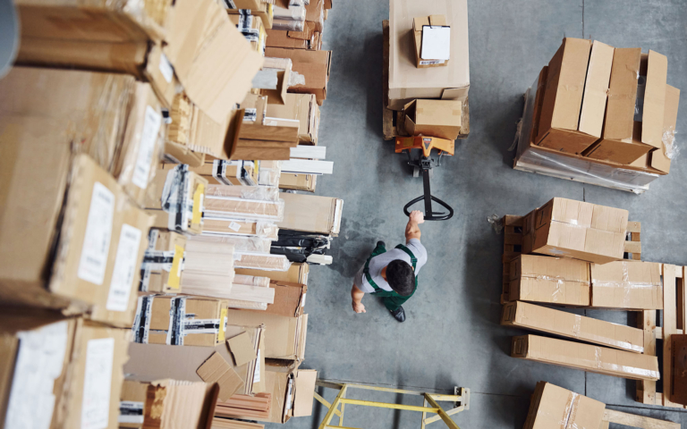 Warehouse worker pulling boxes for parcel shipping