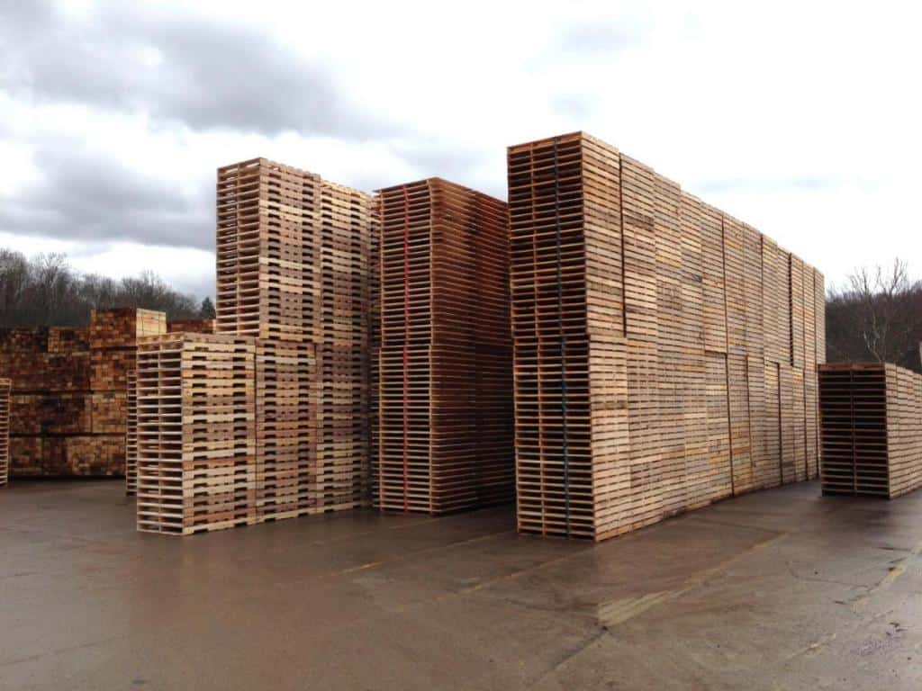 Stacks of new wooden pallets in an outdoor storage yard