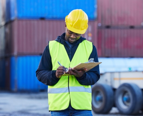 freight worker looking at clipboard