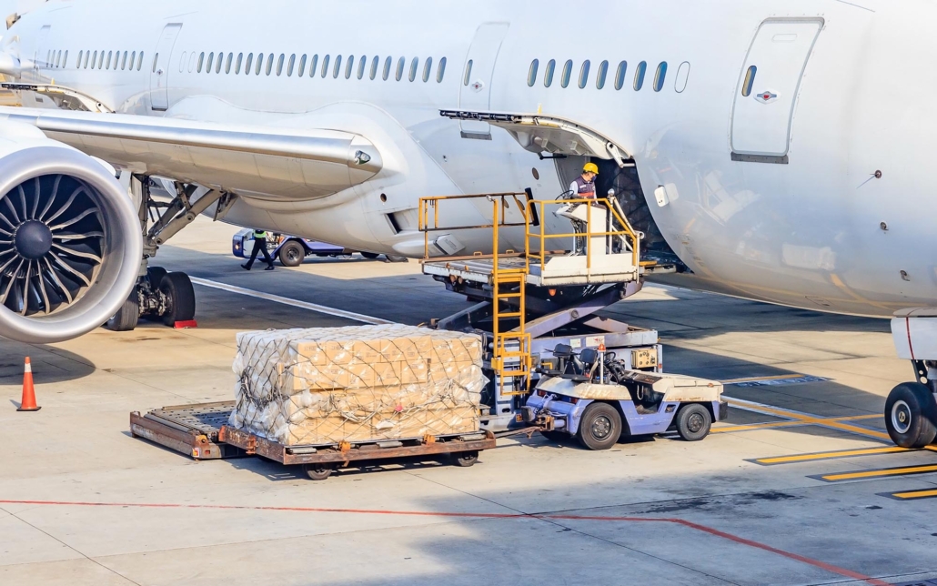 Worker loading packages on plane