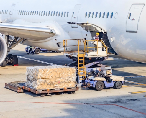 Worker loading packages on plane