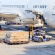 Worker loading packages on plane