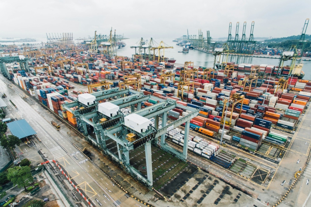 Aerial view of a busy container port with stacked intermodal shipping containers