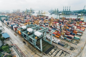 Aerial view of a busy container port with stacked intermodal shipping containers