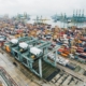 Aerial view of a busy container port with stacked intermodal shipping containers