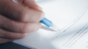 Hand signing a legal document