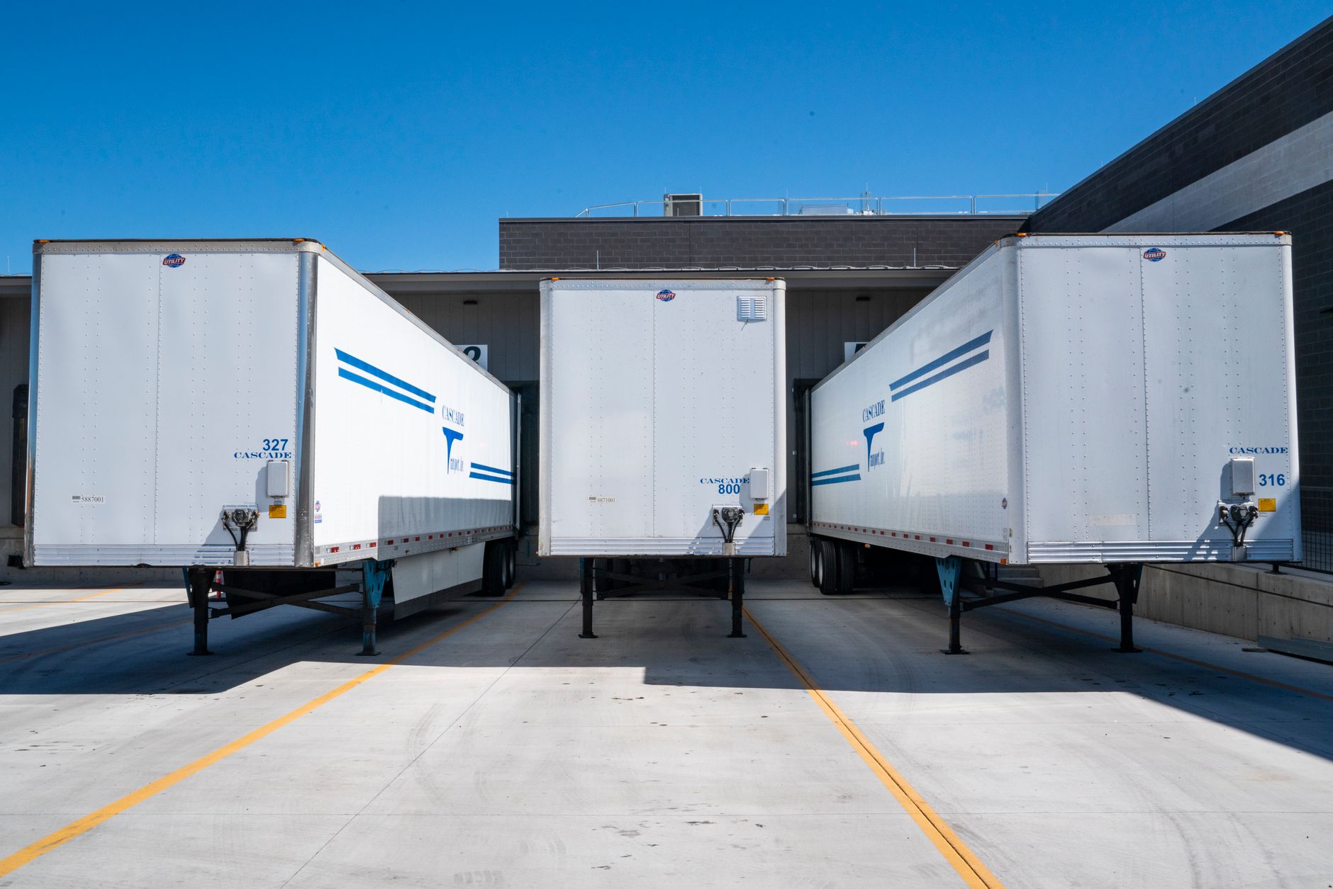 Cargo trailers backed into loading doors at a shipping dock