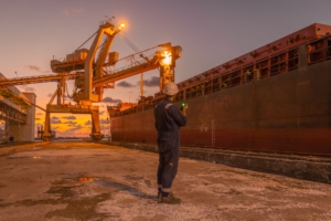Dock worker at a cargo port at twilight