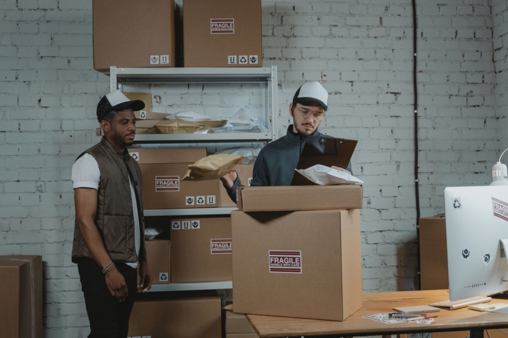 Warehouse workers checking fragile-labeled packages