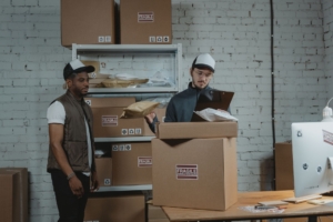 Warehouse workers checking fragile-labeled packages